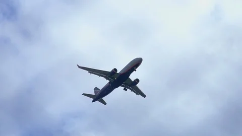 Jet plane in a cloudy sky overhead Stock Footage 126787205