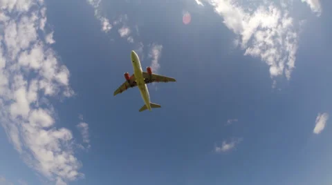 A jet plane flies overhead on final approach. Wide Angle Stock Footage 38094428