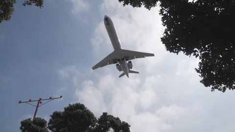 Jet plane flying low about to land in slow motion 120fps Stock Footage 89162414