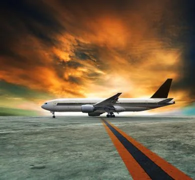 Jet plane flying over runways and beautiful dusky sky with copy space use for Stock Illustration