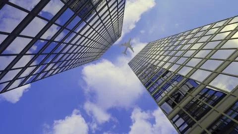 A jet plane flying over two big city downtown skyscraper office buildings Stock Illustration
