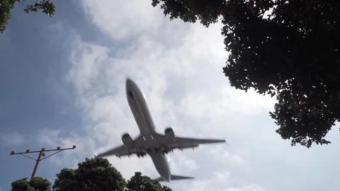 Jet plane flying overhead with landing gear down Stock Footage 89186713