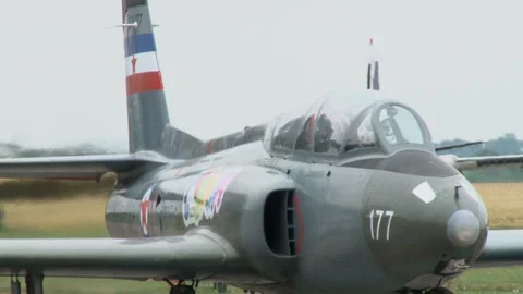 A jet plane is getting ready to take off at a small city airport. Stock Footage 134576895