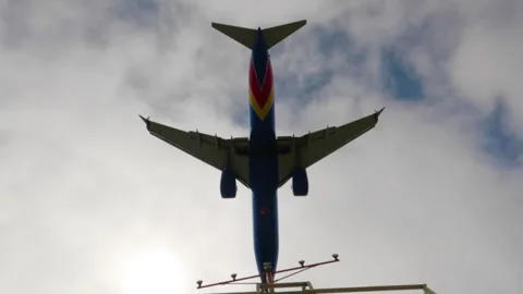 Jet plane landing in silhouette. Tracking shot Stock Footage 240902072
