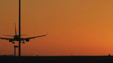Jet Plane landing at sunset Stock Footage 38496594