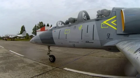 Jet plane move between airplanes at the old airfield on a rainy cloudy day. Stock Footage 118676768