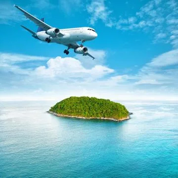 Jet plane over the tropical island Stock Photos