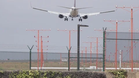 Jet plane shot from behind lands on runway Stock Footage 89186645