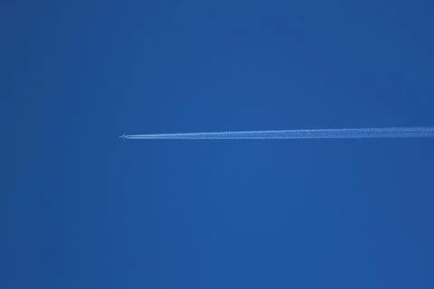 Jet plane in the sky with Condensation trace The only plane in the blue sky Stock Photos