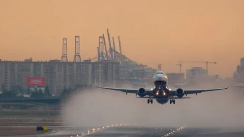 Jet Plane Takes Off from Wet Runway at Sunset Video stock 335018174