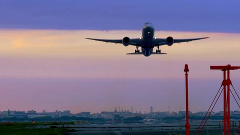 Jet plane taking off in beautifully colored sunset Stock Footage 75693225