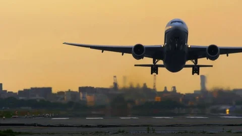 Jet plane taking off in sunset Stock Footage 75694454