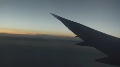 Jet plane wing seen from window as airplane turns Видео 74831778
