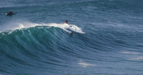 Jet ski bringing surfer on top of ocean wave to ride with tide of Atlantic ocean Stock Footage 163085695