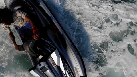 Jet ski circles in shallow water drone view rising up at larger wake circles  Stock Footage 106767916