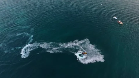 A jet ski creates a splash in the calm waters of Ksamil, Albania, during a Stock Footage 284303254