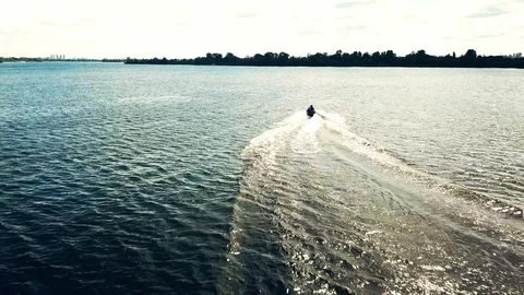 A jet ski cuts through waves at speed. Jet ski on the river in sunny weather Stock Footage 128003804