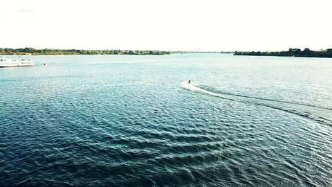 A jet ski cuts through waves at speed. Jet ski on the river in sunny weather Stock Footage 128004741
