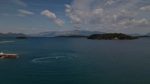 Jet Ski Drawing a Heart Shape on the Ionian Sea Near a Small Island 스톡 동영상 337003716