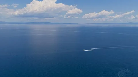 Jet ski making circular wake pattern on calm blue sea Stock Footage 340322939