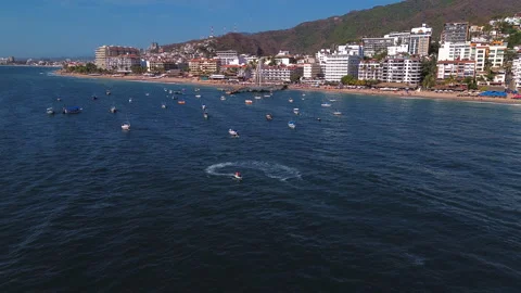 Jet ski navigating sea near Los Muertos pier in Puerto Vallarta at sunset Видео 346192496