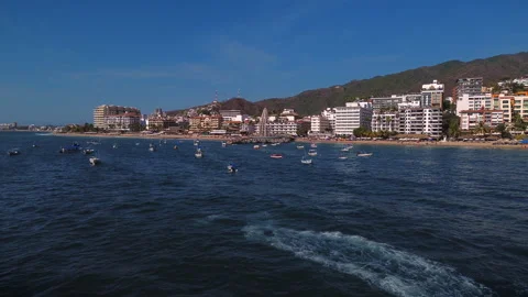 Jet ski navigating sea near Los Muertos pier in Puerto Vallarta at sunset Видео 346192501