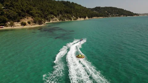 Jet Ski Pulling Towable Tube Right-to-Left Aerial, Kassandra Greece Stock Footage 329018424