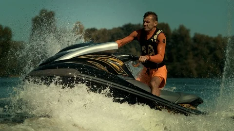 Jet ski rider having fun on waves in slow motion. Man ride jet ski on river Stock Footage 96181789