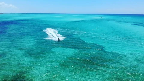 Jet Ski Rider Splashing Through Tropical Waters at Fortuna Beach, Bahamas Stock Footage 108331555