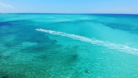 Jet Ski Rider Splashing Through Tropical Waters at Fortuna Beach, Bahamas Stock Footage 108331696