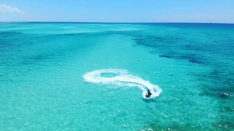 Jet Ski Rider Splashing Through Tropical Waters at Fortuna Beach, Bahamas Stock Footage 108331835