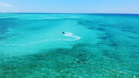 Jet Ski Rider Splashing Through Tropical Waters at Fortuna Beach, Bahamas Stock Footage 108332195