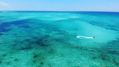 Jet Ski Rider Splashing Through Tropical Waters at Fortuna Beach, Bahamas Stock Footage 108332272