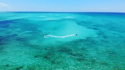 Jet Ski Rider Splashing Through Tropical Waters at Fortuna Beach, Bahamas Stock Footage 108332280