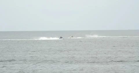Jet ski riding on calm ocean waters near the shore in the afternoon Stock Footage 281816586