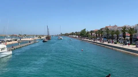 Jet ski riding through the harbour channel on a clear day Stock Footage 107483748