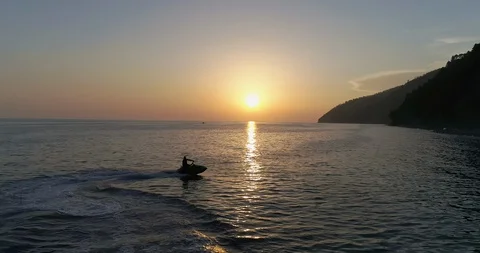 Jet ski is sailing on the sea under sunset. Stock Footage 129731201