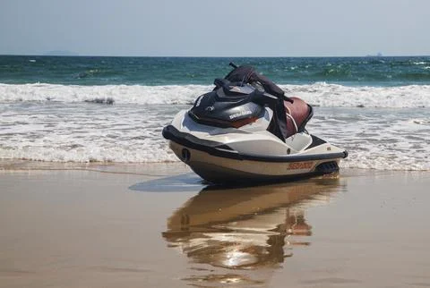 Jet ski on the sandy beach with reflection of the sea in the water Fotos de archivo