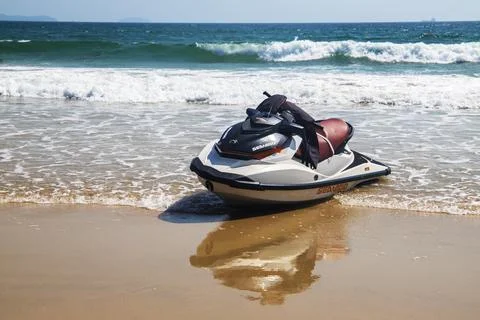 Jet ski on the sandy beach with reflection of the sea in the water Fotos de archivo