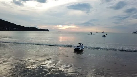 Jet ski seating alone on a beach at sunset Stock Footage 88162290
