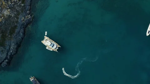 Jet ski top view rolls around the yacht in Bay of the sea Stock Footage 116906644