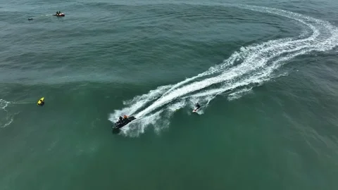 Jet ski towing surfer in deep water near Nazaré Stock Footage 309001422