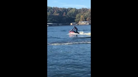 Jet skier makes a splash with a double flip during stunt jump attempt Stock Footage 109394442