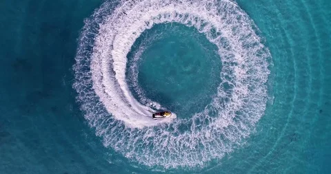 Jet skiing in circles in the Indian ocean. Powerful jet ski. Medium shot Stock Footage 98175310
