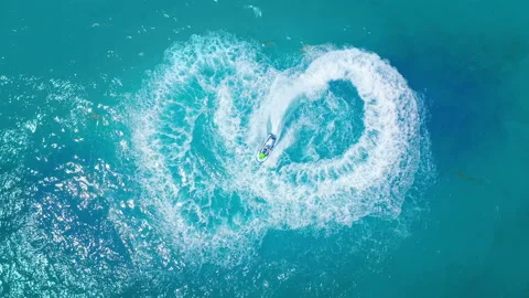 Jet Skiing In Circles in Shape of Heat in the Ocean Stock Footage 114580595