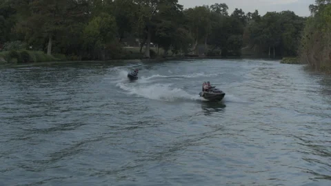Jet skis speeding over the surface of the water at the river Stock Footage 323465633