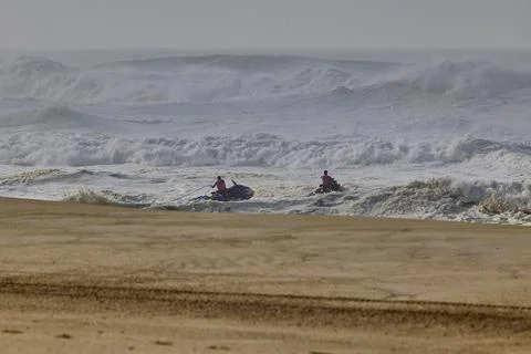 Jet skis in the water while Big waves crushing in winter season in Nazare Stock Photos