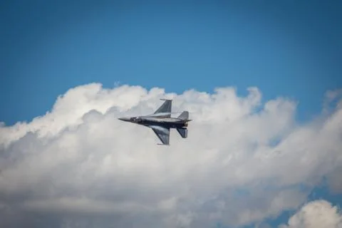 Jet In Sky Against Clouds Stock-Fotos