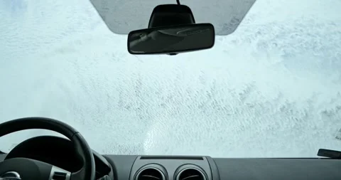 Jet spray washing active foam off car windshield inside cabin POV Stock Footage 338338798