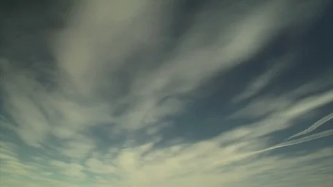 Jet trails and clouds in the sky Stock Footage 74089873